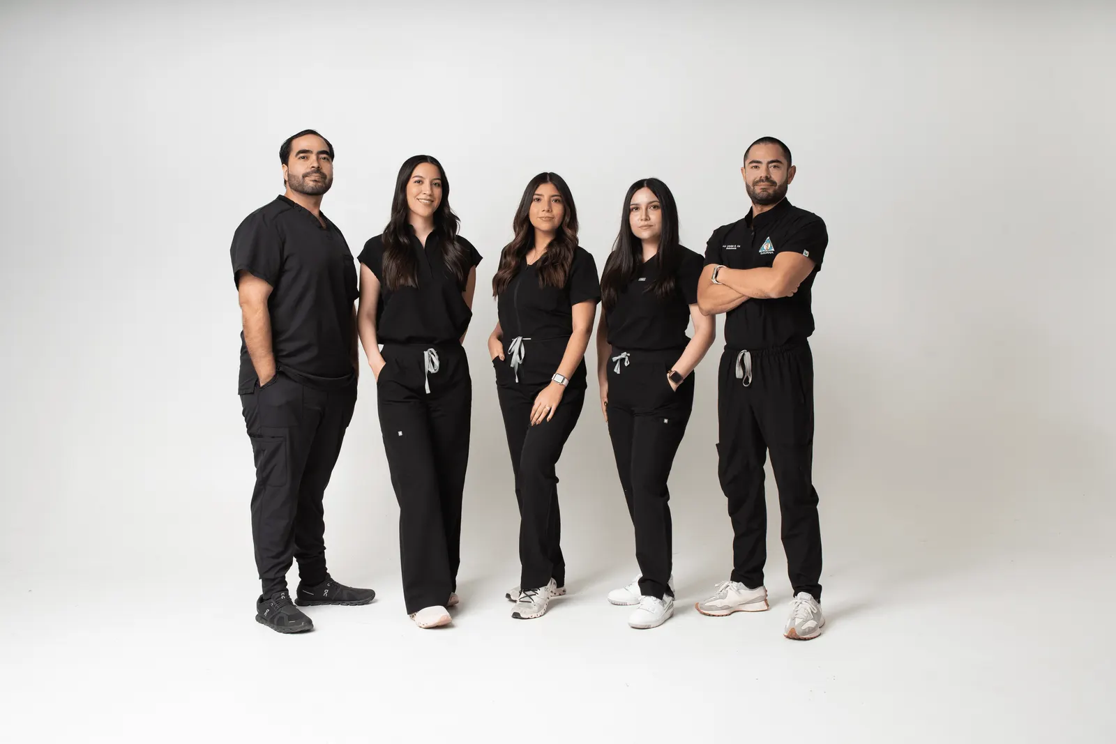 The Allure RT MX dental team in branded black scrubs against a clean studio backdrop at our Tijuana partner clinic